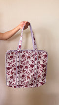 Hand-block printed quilted cotton tote bag. Featuring berry-toned florals, winding vines against an ivory backdrop.