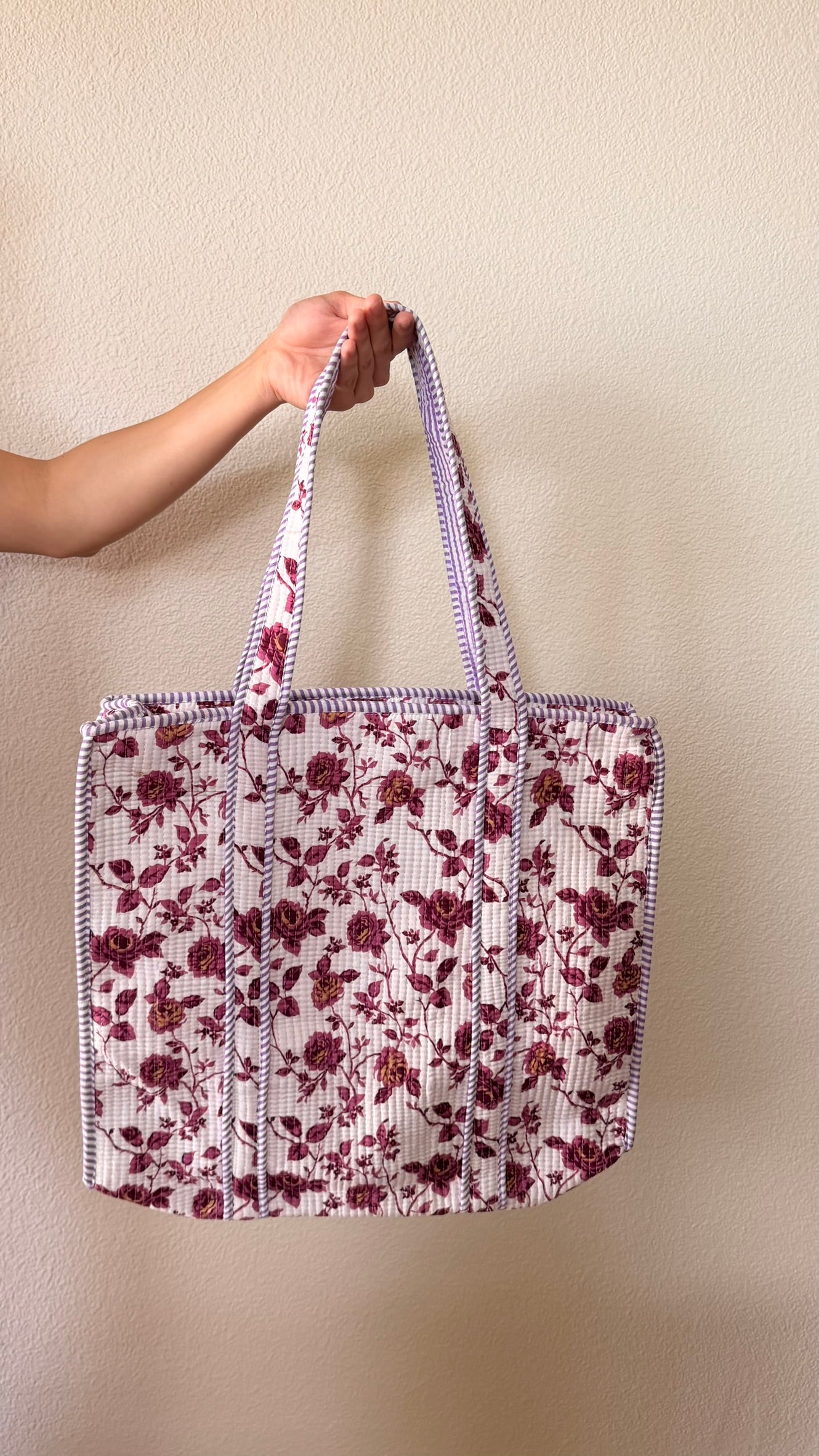 Hand-block printed quilted cotton tote bag. Featuring berry-toned florals, winding vines against an ivory backdrop.