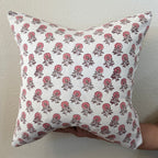 Hand Block printed throw pillow with floral motifs in soft pink on white.