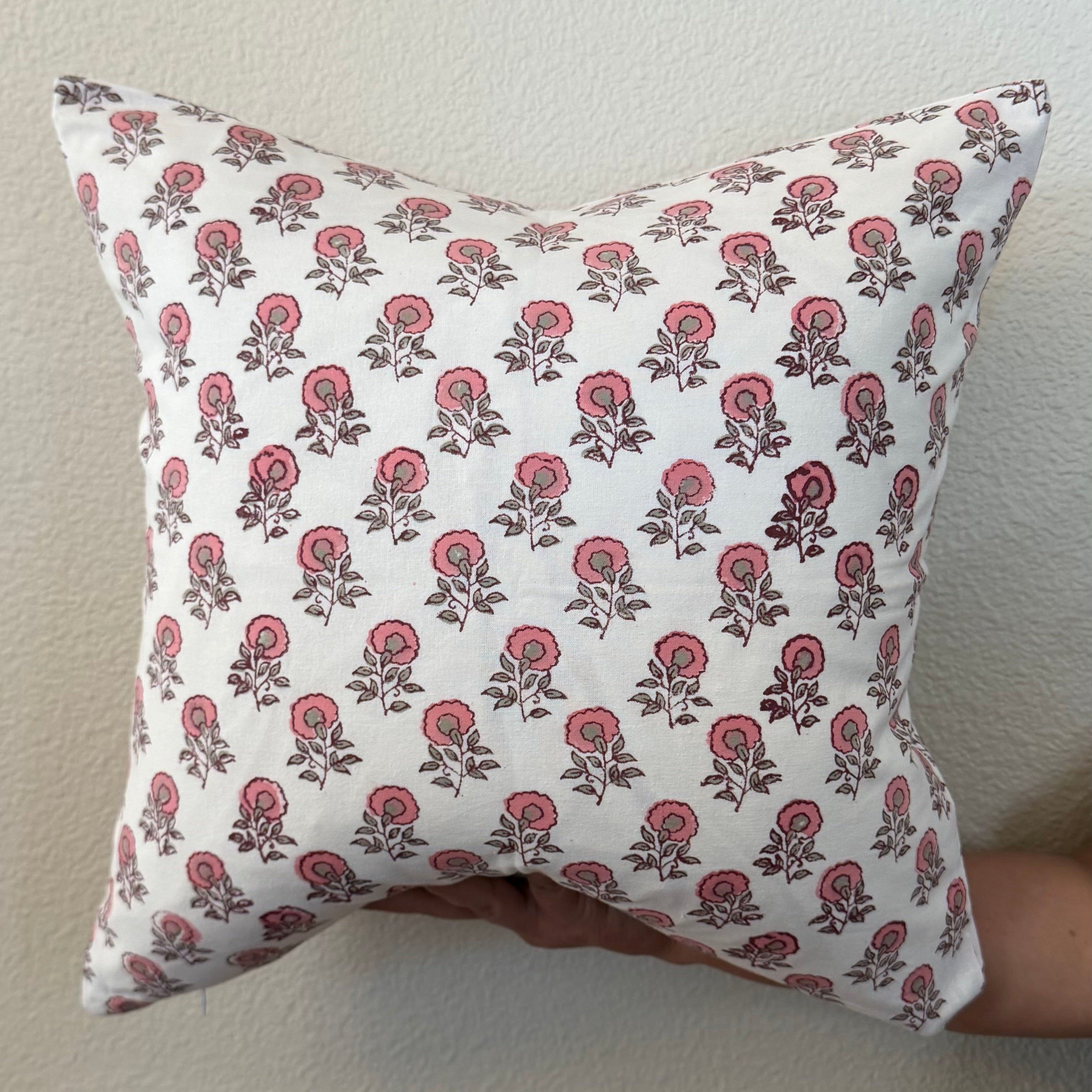 Hand Block printed throw pillow with floral motifs in soft pink on white.