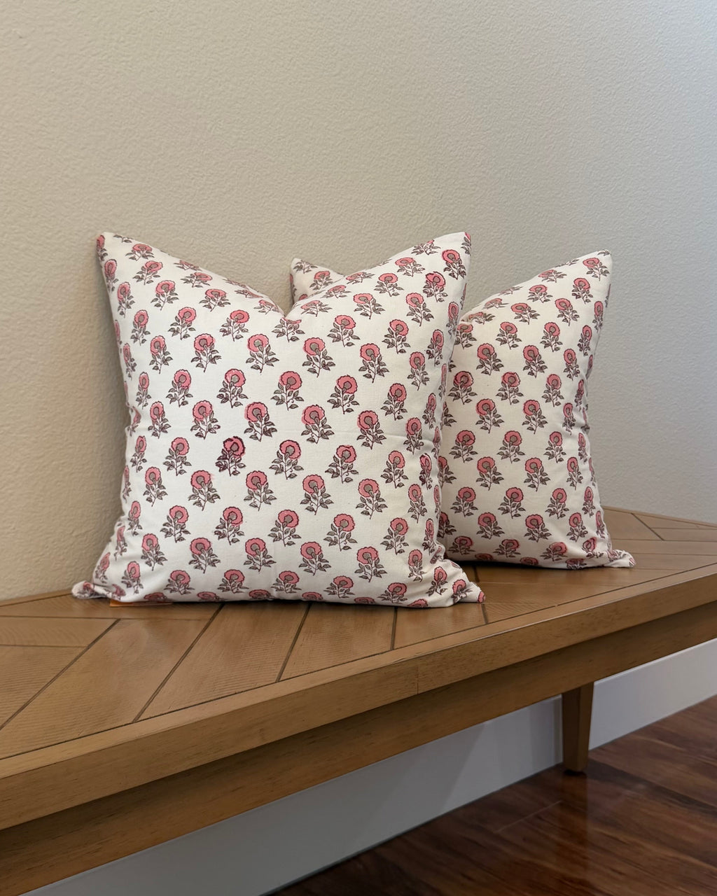 Hand Block printed throw pillow with floral motifs in soft pink on white.