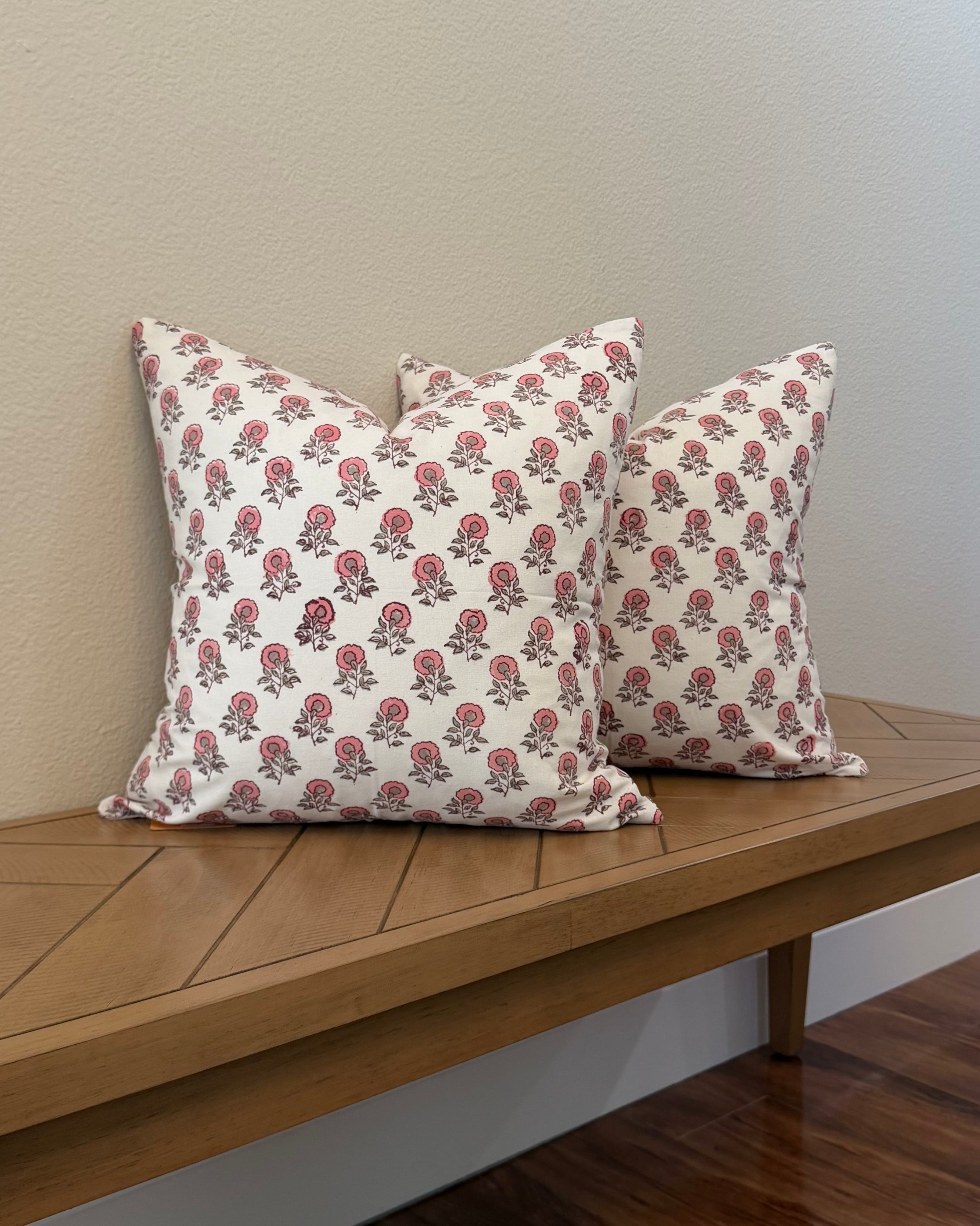 Hand Block printed throw pillow with floral motifs in soft pink on white.