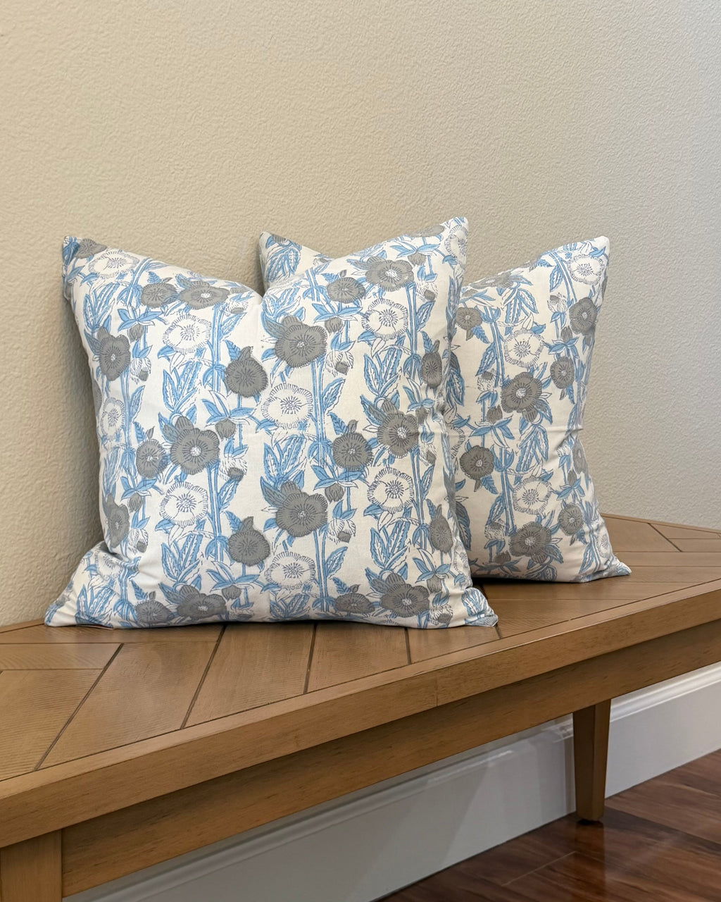 Hand Block printed throw pillow with floral motifs in muted Blues and Grays.