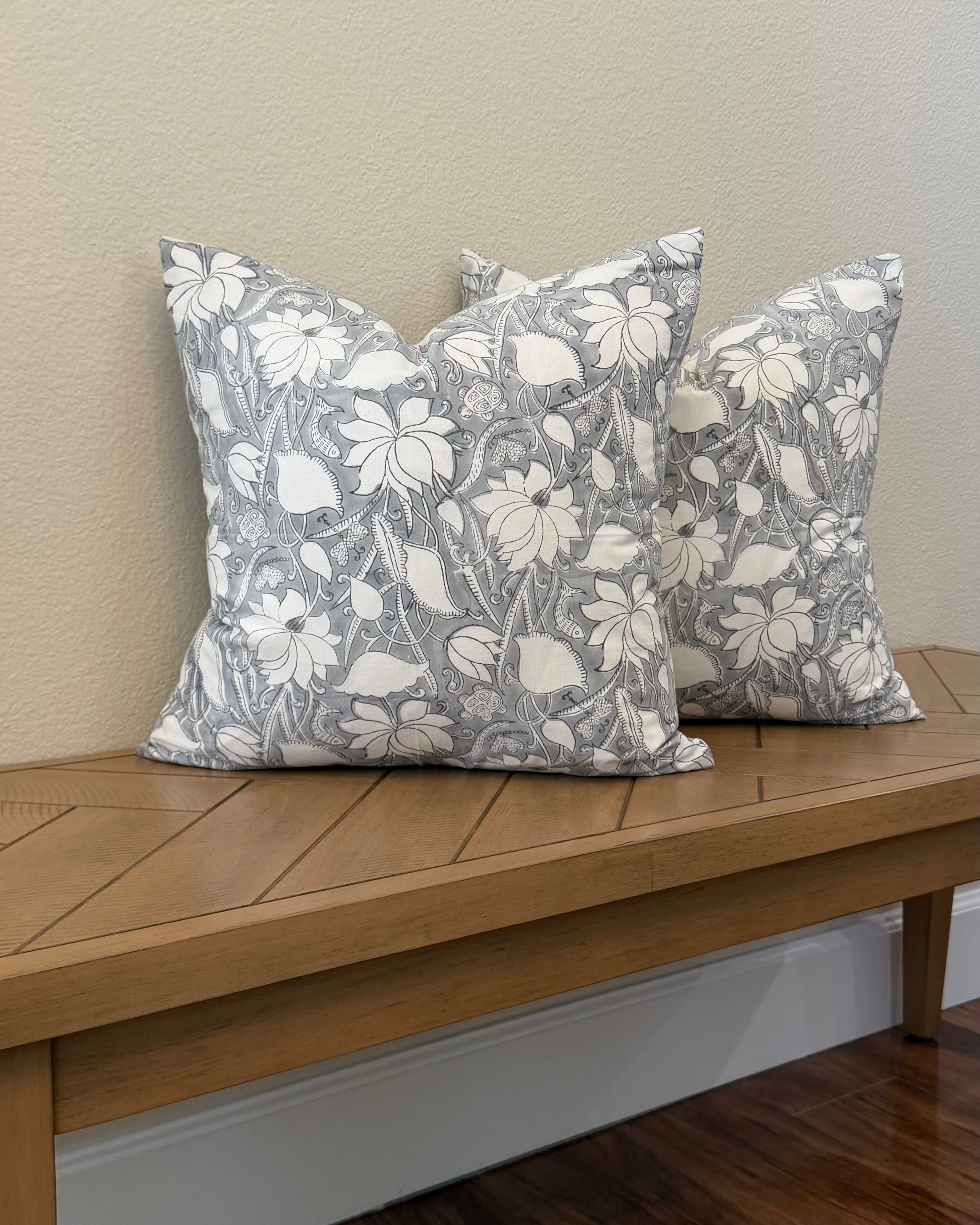 Hand Block printed throw pillow with floral Lotus vine motifs in muted gray and white.