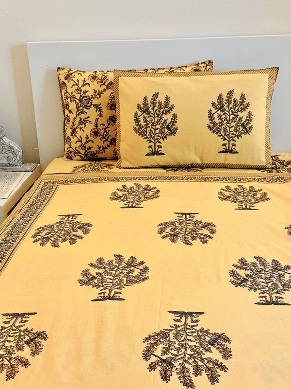 Foundation Edit Parrot Perch hand-block printed South Cotton bedsheet set by DewDropHues, featuring an intricate tree and parrot motif and breathable heritage weave.