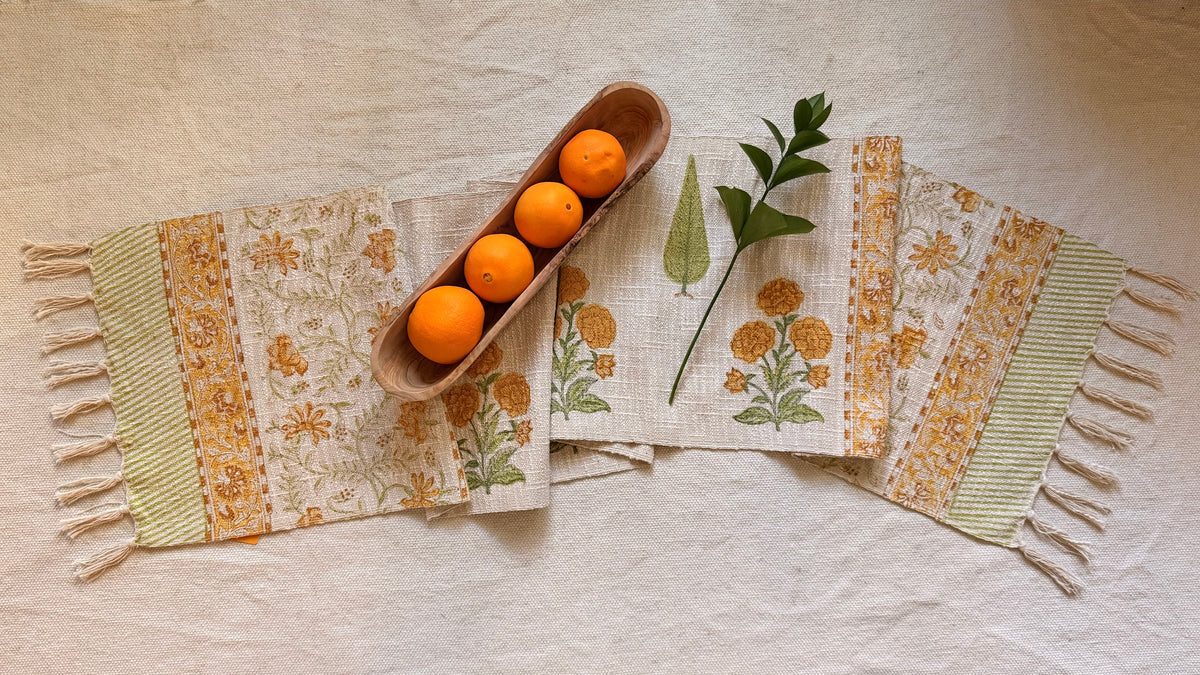 Slub Cotton table runner with fringes. Hand block printed in bright orange and green florals.