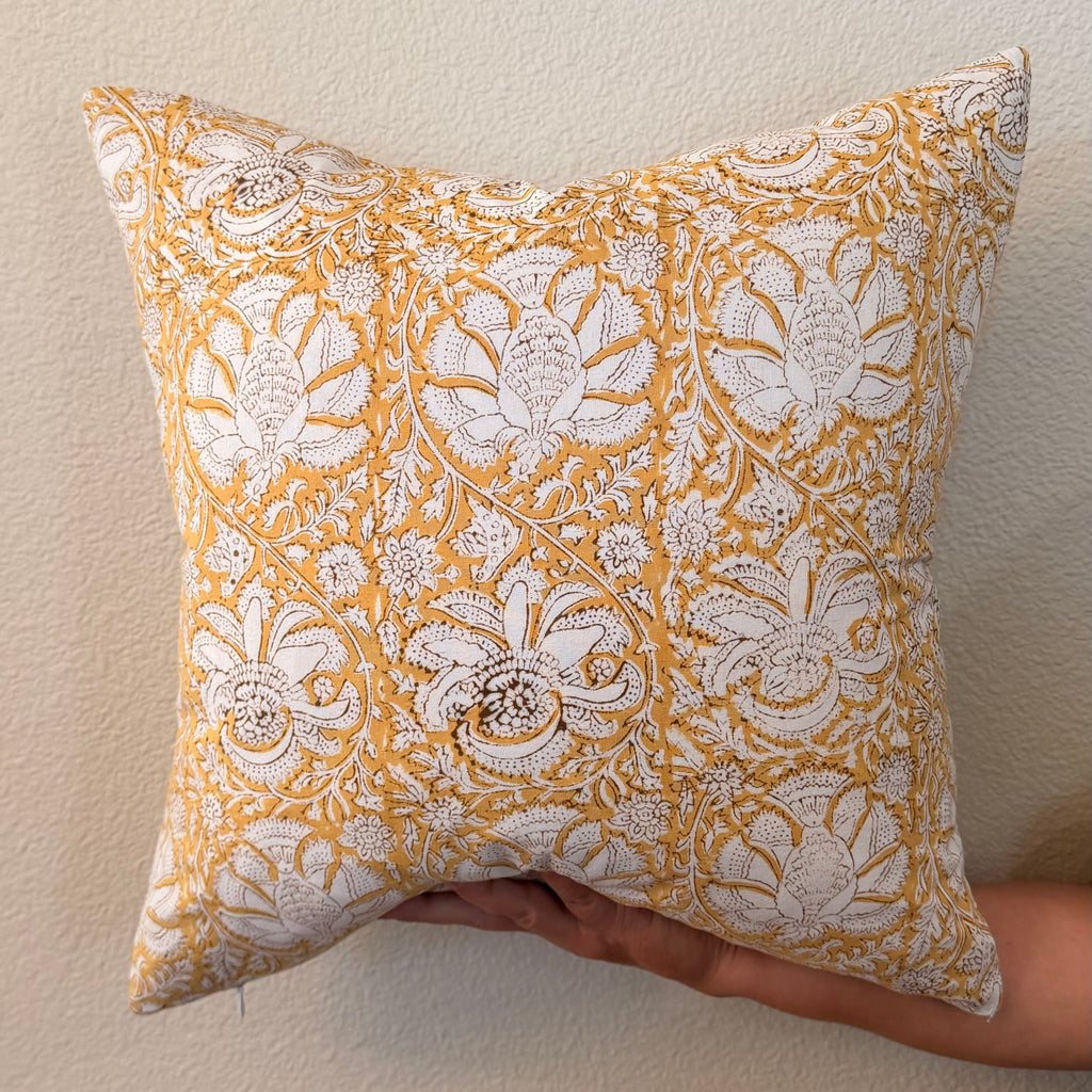 Hand Block printed throw pillow with floral vine motifs in muted ochre and brown.