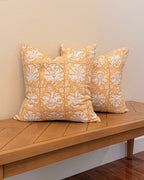 Hand Block printed throw pillow with floral vine motifs in muted ochre and brown.