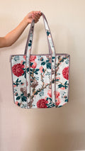Hand-block printed quilted cotton tote bag. White background with large floral prints in red and teal green.