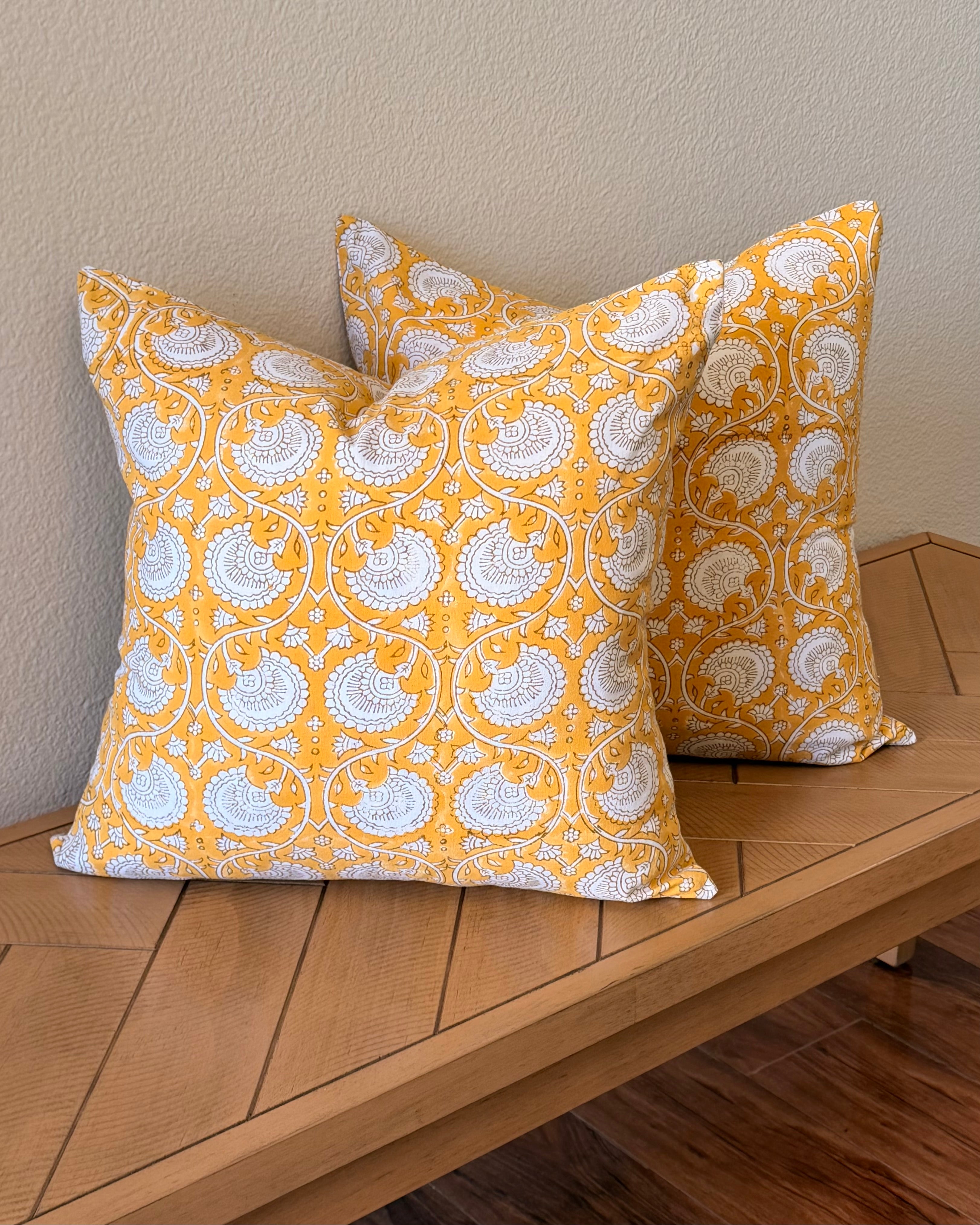 Hand Block printed throw pillow with floral vine motifs in bright ochre yellow and gray.
