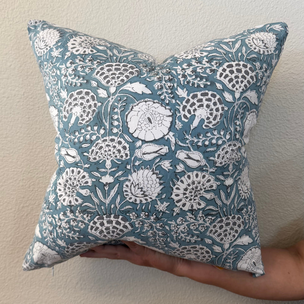 Hand Block printed throw pillow with floral vine motifs in muted bluish gray and white.