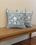 Hand Block printed throw pillow with floral vine motifs in muted bluish gray and white.