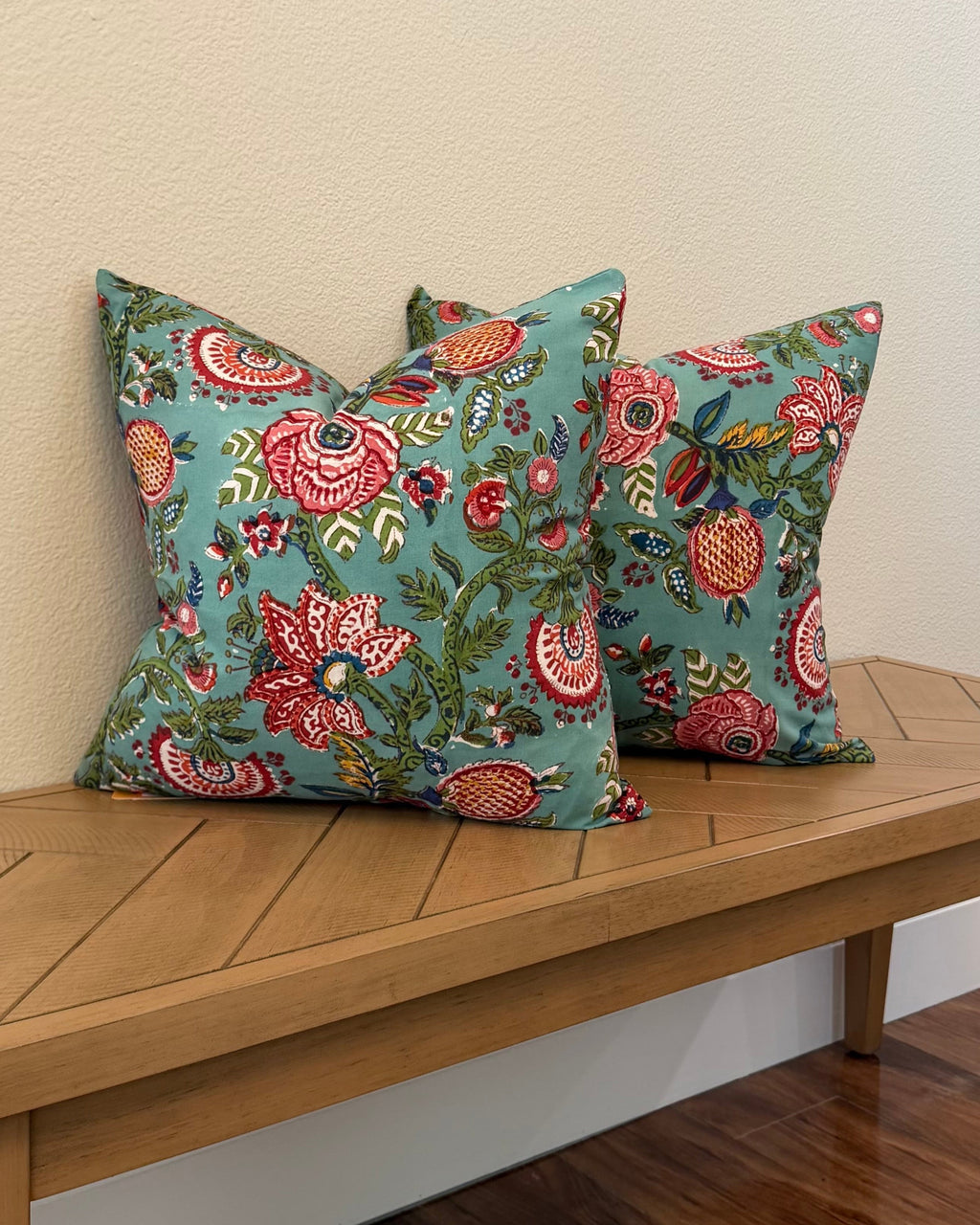 Hand Block printed throw pillow with floral motifs in bright Crimson and Turquoise.
