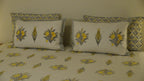 Foundation Edit Zesty Bliss hand-block printed South Cotton bedsheet set by DewDropHues, featuring a lemon motif design and premium yellow lattice border.