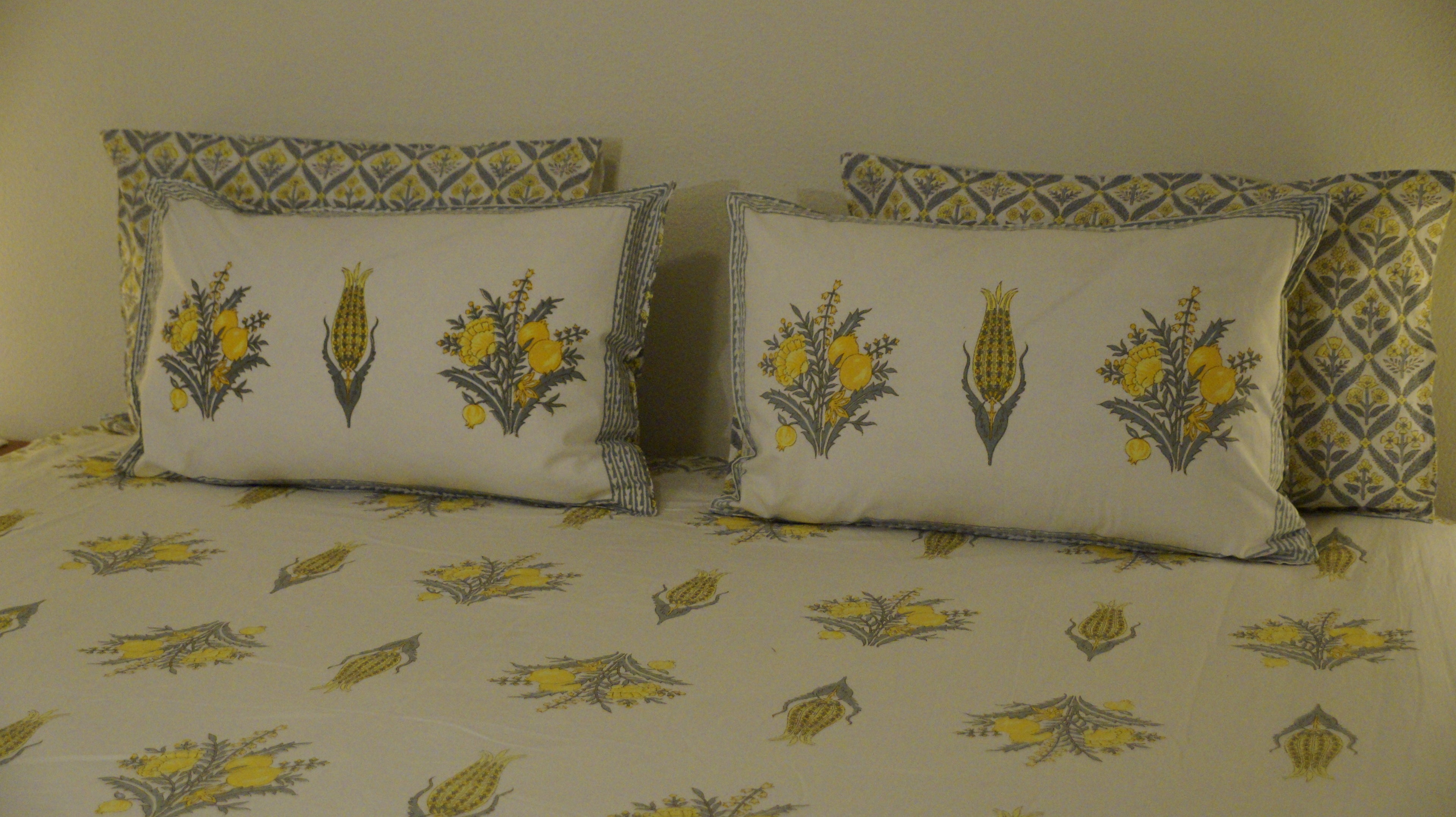 Foundation Edit Zesty Bliss hand-block printed South Cotton bedsheet set by DewDropHues, featuring a lemon motif design and premium yellow lattice border.